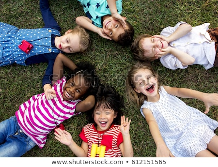 Foto d'archivio: Group Lying On Grass In A Circle