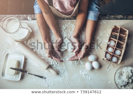 Stockfoto: Beautiful Little Girl With The Mother In The Kitchen Preparing A