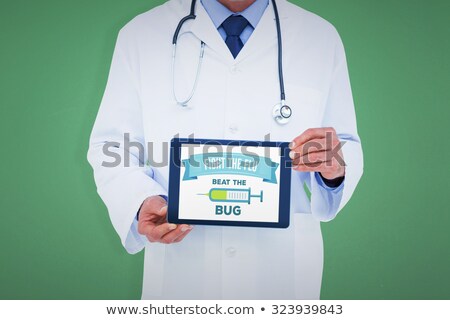 Foto stock: Doctor Holding An Injection In Front Of Computer At Clinic