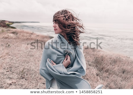 Stok fotoğraf: Young Woman Standing In Sand Dunes Wrapped In Blanket