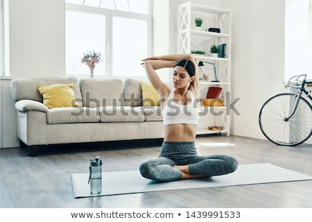 Zdjęcia stock: Young Woman In Warm Clothing And Practicing Yoga