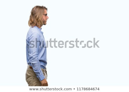 Stock photo: Serious Man With Beard And Long Hair Looking Away