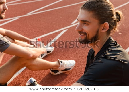 Stok fotoğraf: Twins Sportsmen Brothers Sitting At The Stadium Outdoors