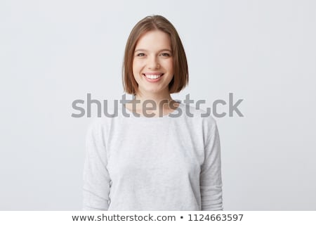 Stock fotó: Glad Brunette Female With Pleasant Smile Has Long Dark Hair Indicates With Fore Finger Upwards Sh