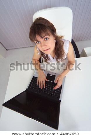 Amusing Woman Sits At Table With Computer - Top View Stockfoto © pzAxe