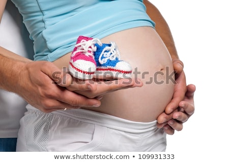 Zdjęcia stock: Pregnant Woman Holding A Pair Of Pink Baby Booties