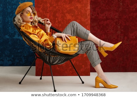 Stok fotoğraf: Fashion Woman Posing On Chair