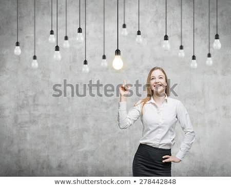 Stock fotó: Woman Pointing At Light Bulb