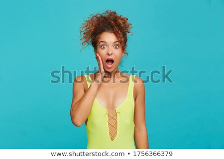 Stok fotoğraf: Shocked Brunette Woman In Casual Clothes Holding Her Cheeks