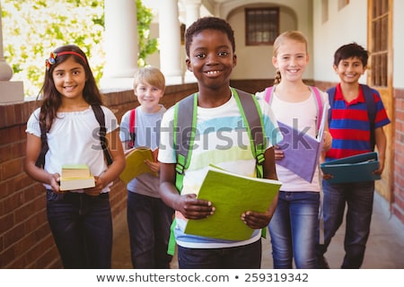 Stockfoto: Happy School Kids Standing And Looking At Camera In Classroom Of Elementary School