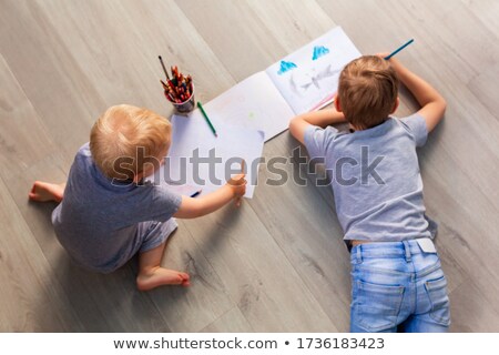 Stock photo: Preschool Boys Drawing On Floor On Paper Playing With Educational Toys - Blocks Train Railroad V