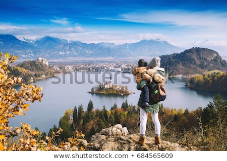 Foto stock: Woman Traveler Hiking In Winter Mountains