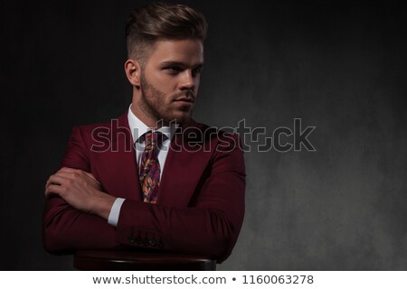 Foto stock: Stylish Man Relaxing At Wooden Bar Table Looks To Side