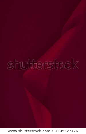 商業照片: Abstract Curly Silk Ribbon On Wine Background Exclusive Luxury