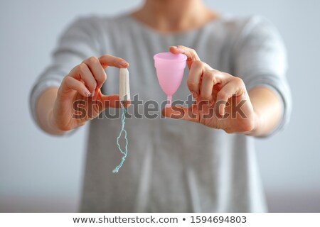 Zdjęcia stock: Young Woman Hands Holding Different Types Of Feminine Hygiene Products - Menstrual Cup And Tampons