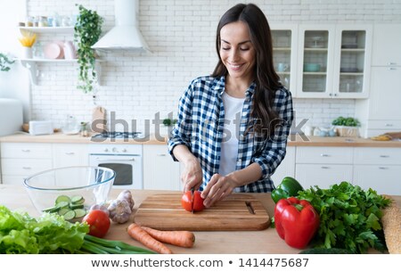 Stock fotó: Happy Woman Cutting Vegetables