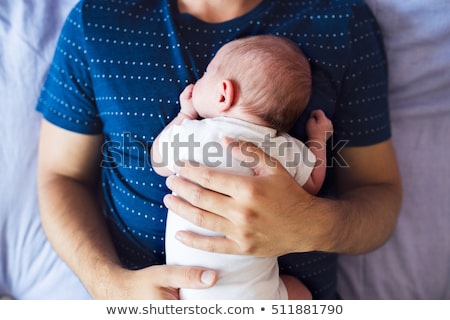 Foto stock: Newborn Boy Lying On His Dads Arms