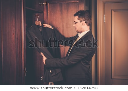 Zdjęcia stock: Middle Aged Man Taking Suit From Wardrobe