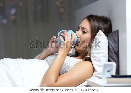 Foto stock: Sad Alone Woman Drinking Coffee In Dark Room