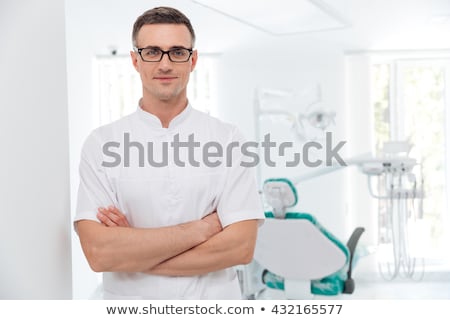 Foto d'archivio: Dentist In Surgical Mask Looking At Camera