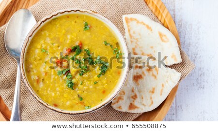 Foto stock: Lentil Soup With Bread In A Ceramic White Bowl On A Wooden Background Top View
