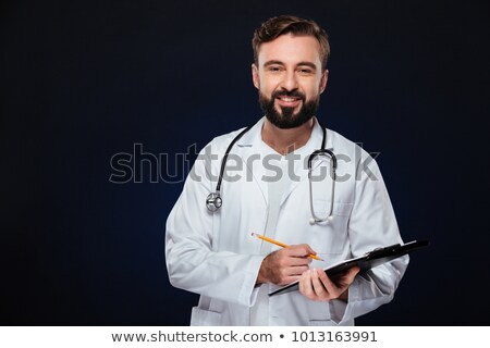 Foto stock: Portrait Of A Smiling Male Doctor Dressed In Uniform