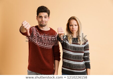 [[stock_photo]]: Portrait Of An Upset Young Couple Dressed In Sweaters