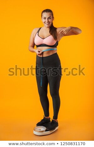 Foto stock: Full Length Portrait Of A Satisfied Overweight Young Woman