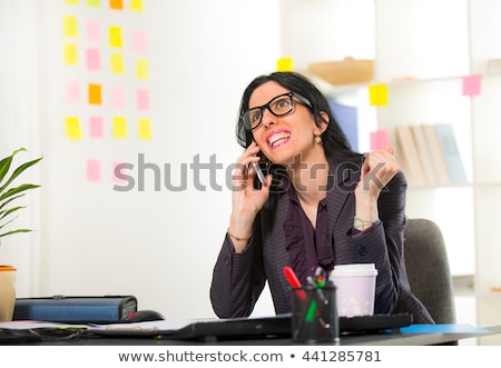 Zdjęcia stock: Cheerful Young Businesswoman Sitting At Her Workplace