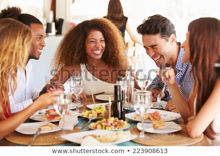 Foto stock: Female Friends Eating At Restaurant