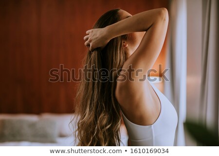 Stock foto: Portrait Of Pretty Young Woman Flinging Long Brown Hair Into Air