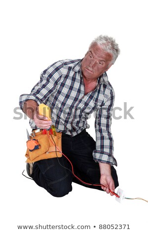 Stock photo: An Electrocuted Tradesman Staring At His Multimeter