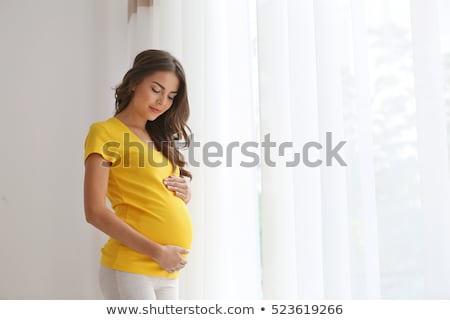 Сток-фото: Pregnant Woman Stands In The Room