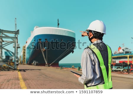 Foto stock: Worker Standing At Anchor In Shipyard