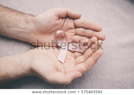 Foto d'archivio: Man Holding Pink Ribbon