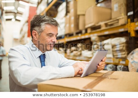 Foto stock: Manual Worker With Tablet Pc At Warehouse
