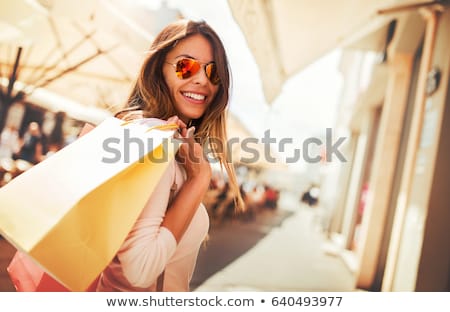 Stok fotoğraf: Women With Shopping Bags Looking At Shop Window