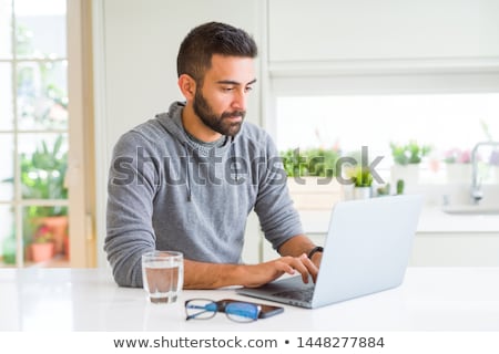 Stok fotoğraf: Indian Man Using Computer At Home