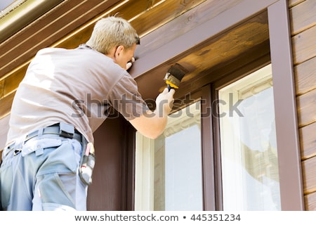 ストックフォト: Man With Paintbrush Painting Wooden House Exterior