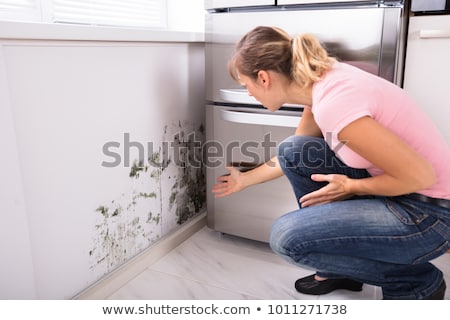 ストックフォト: Shocked Woman Looking At Mold On Wall