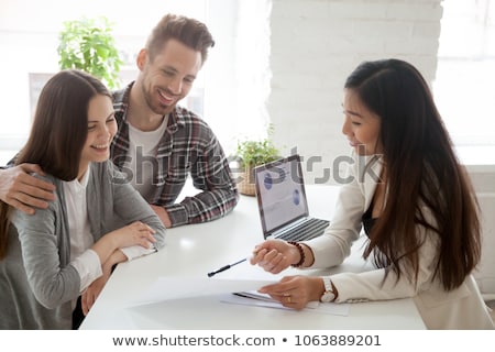Сток-фото: Realtor Showing New House To Couple In Laptop