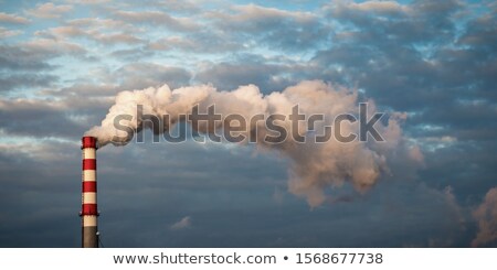 Stock photo: Pipe Industrial Chimney With Smoke Against The Sky And Clouds