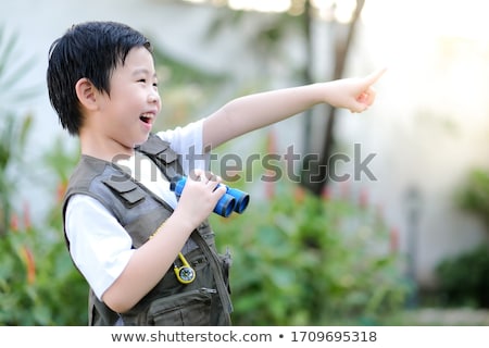 Stok fotoğraf: Little Girl Exploring Map With Finger