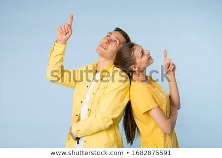 ストックフォト: Young Loving Couple Standing Isolated Over Yellow Wall Background Play Games With Joysticks