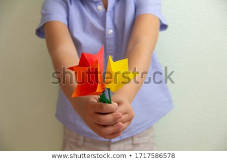 Stockfoto: Grandmother And Girl Study Flowers At Garden