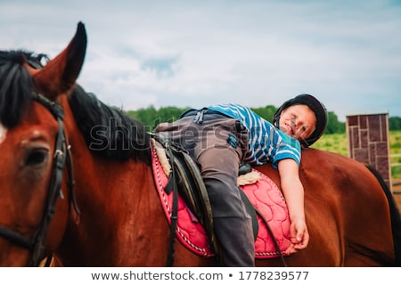 Zdjęcia stock: Boy Horseback Riding Performing Exercises On Horseback