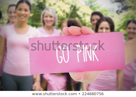 Foto stock: Hand Holding Card With Pink Breast Cancer Awareness Women