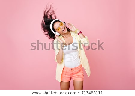 Stockfoto: Happy Girl Listening To Music With Headphones And Dancing