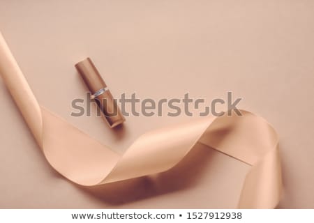 Stockfoto: Luxury Lipstick And Silk Ribbon On Beige Holiday Background Mak