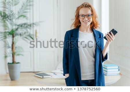 [[stock_photo]]: Half Length Shot Of Beautiful Woman Uses Modern Cellular For Blogging In Social Networks Poses In O